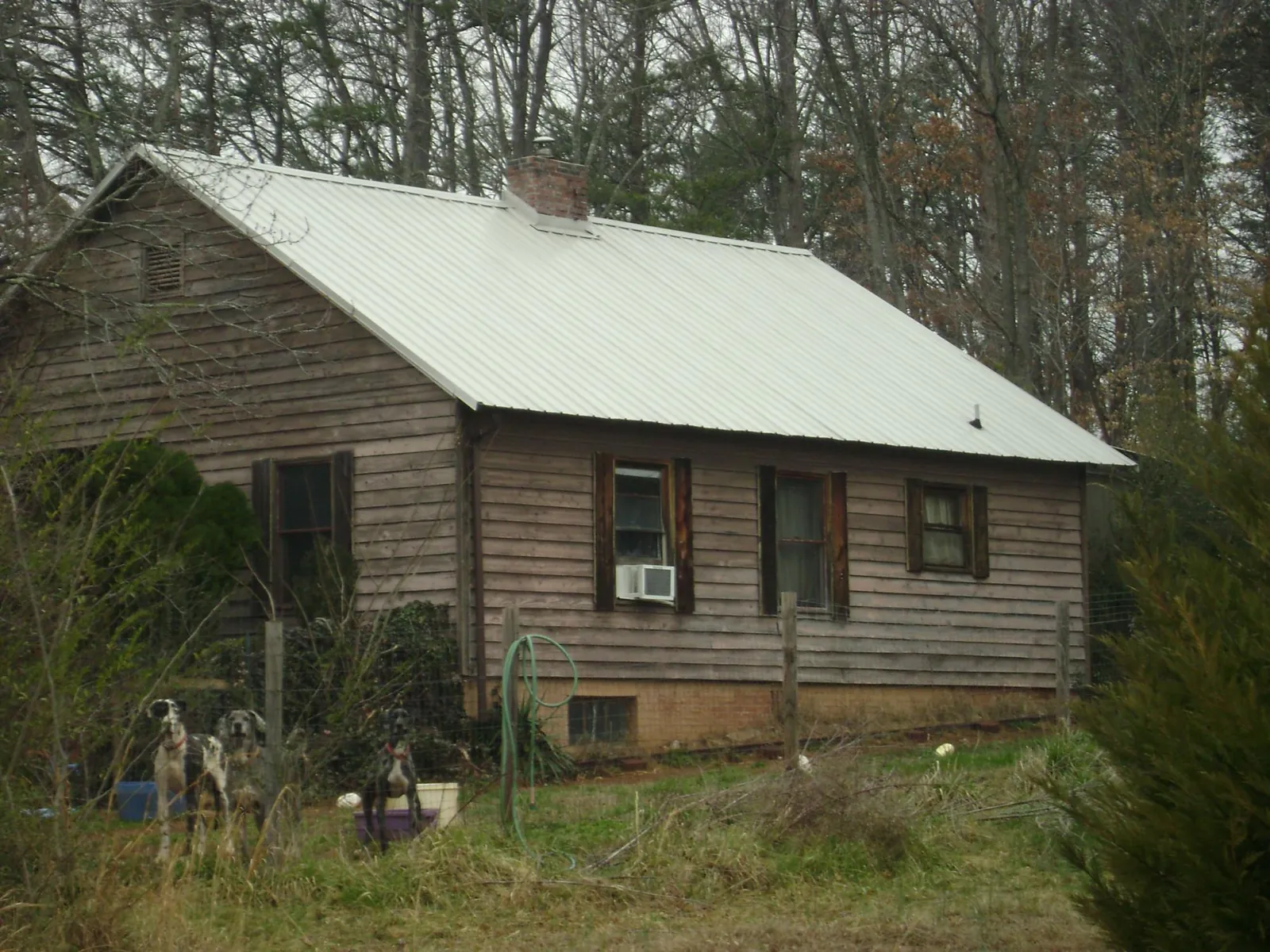White metal roof on an old wood sided farmhouse, from a Metal Roof Installation job in Jamesport